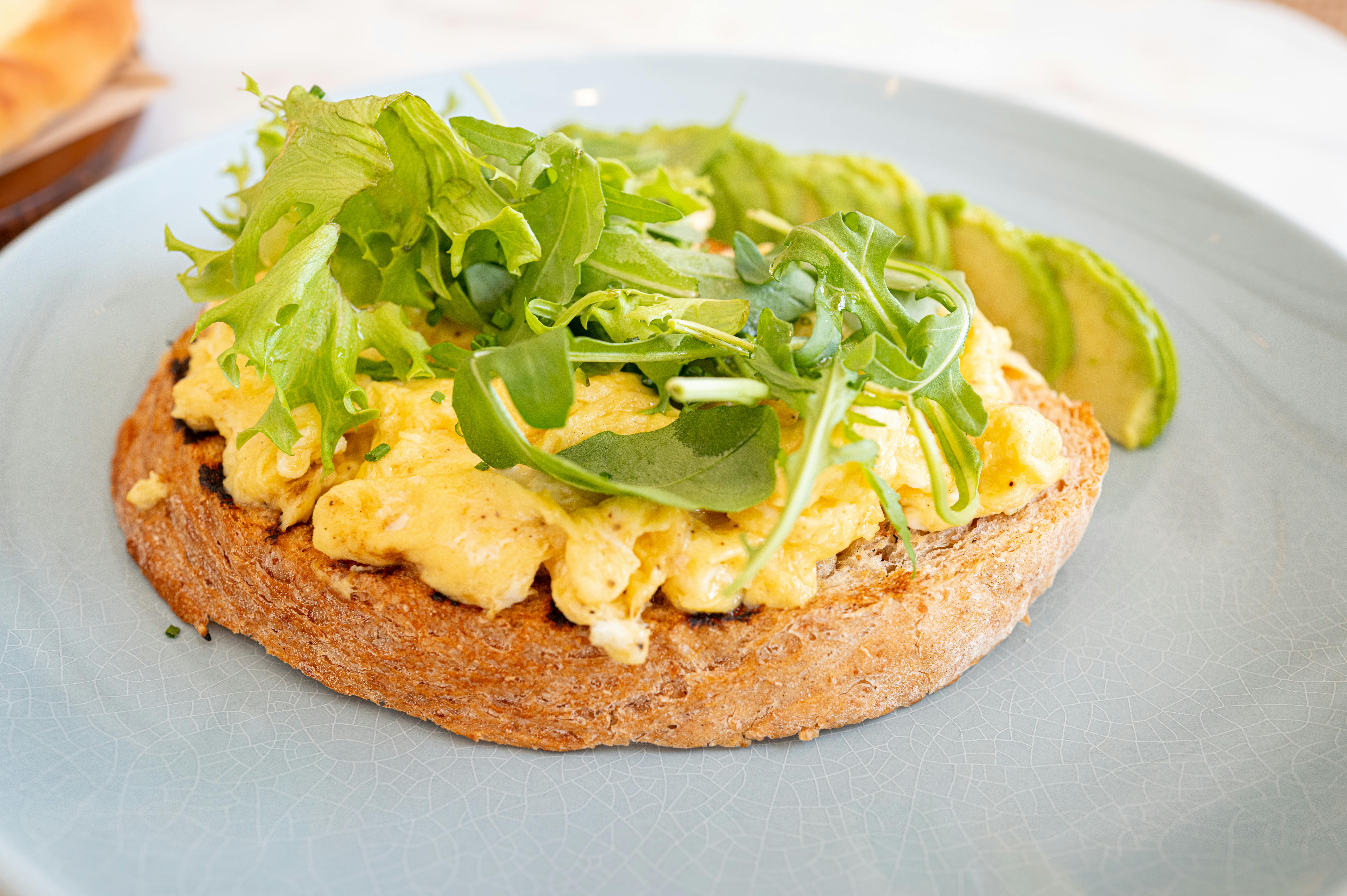 Fluffy scrambled eggs with fresh spinach